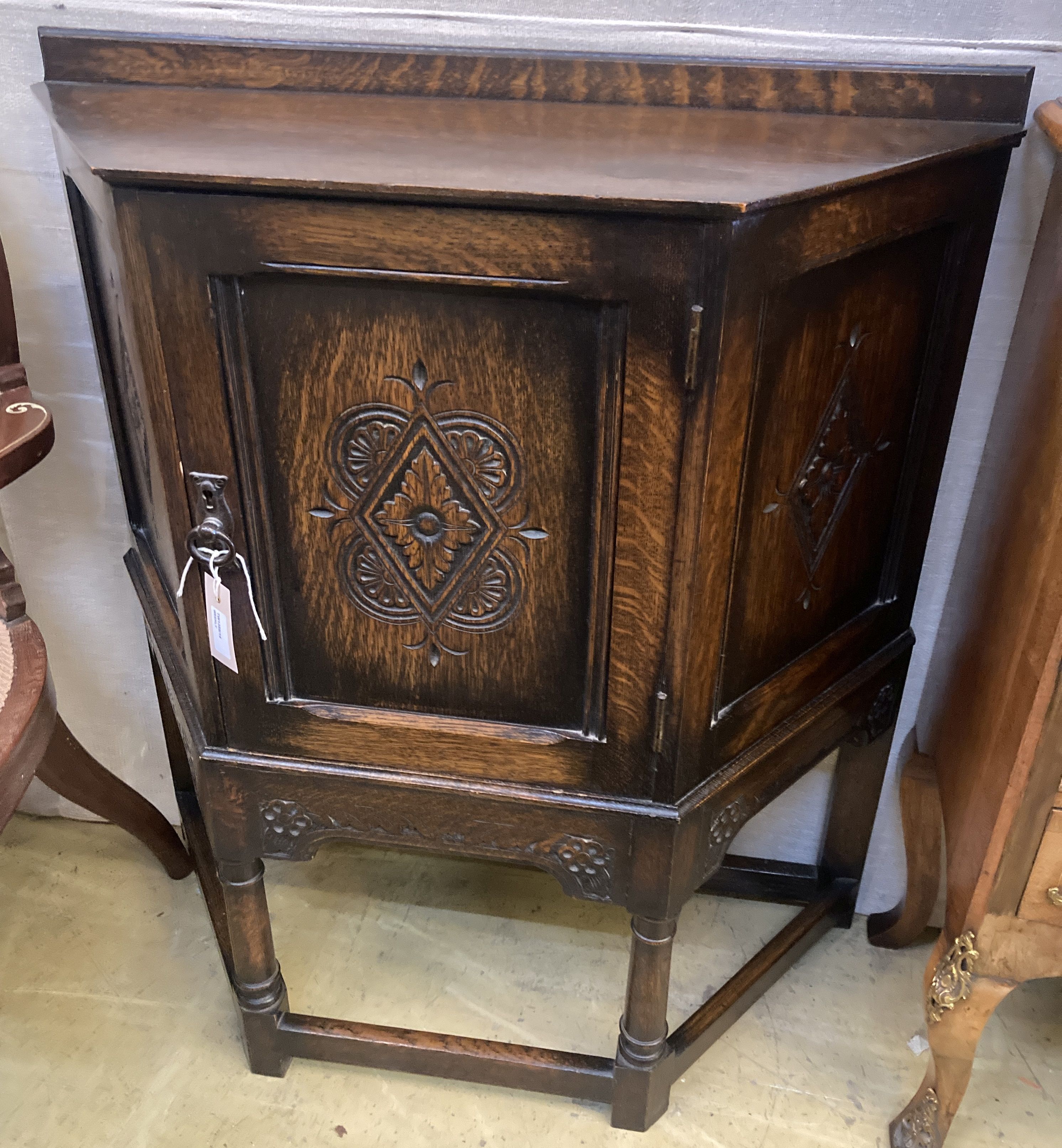 An 18th century style carved oak side cabinet, width 90cm, depth 32cm, height 88cm
